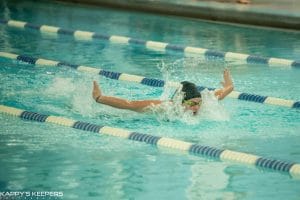Athlete swimming butterfly stroke.
